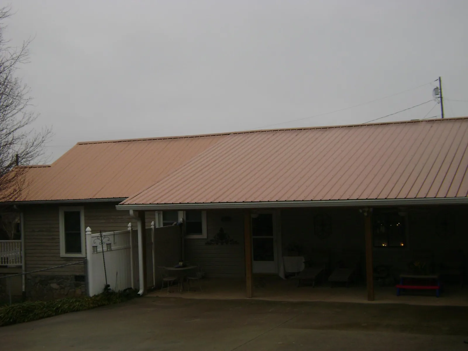 Copper toned metal roof over a wide covered patio in Falmouth